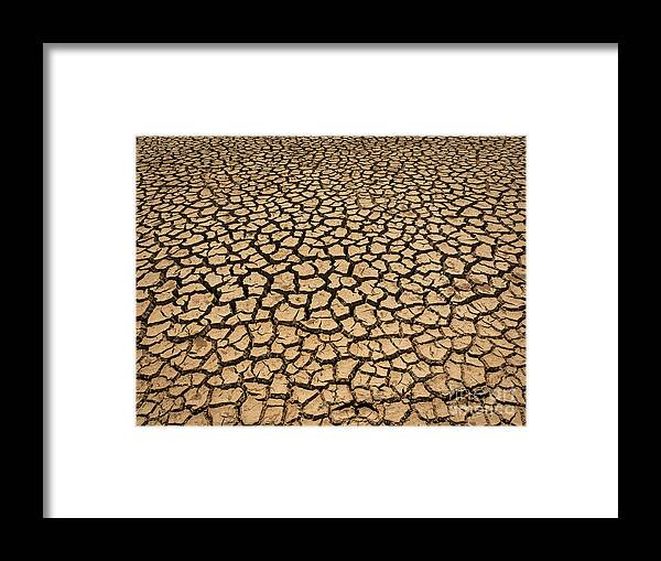 Abstract Framed Print featuring the photograph Dried And Cracked Soil In Arid Season. by Tosporn Preede