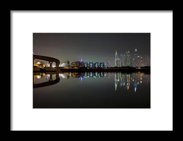 Dubai Framed Print featuring the photograph Dubai city skyline night time reflection by Andy Myatt