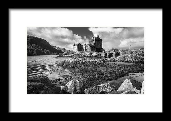 Eilean Donan Framed Print featuring the photograph Eilean Donan Castle in black and white by Holly Ross