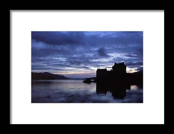 Eilean Donan Framed Print featuring the photograph Eilean Donan Castle over Loch Duich. by John Paul Cullen