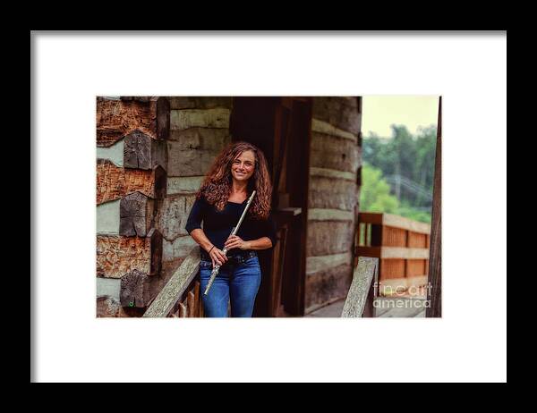 Nina Assimakopoulos Framed Print featuring the photograph Female flute player at log cabin by Dan Friend