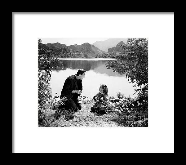 Frankenstein Framed Print featuring the photograph Frankenstein by the lake with little girl Boris Karloff by Vintage Collectables