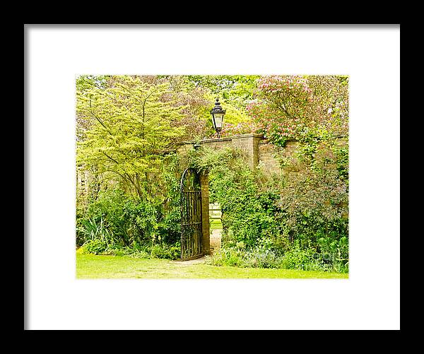 Garden Wall Framed Print featuring the photograph Garden Wall With Iron Gate And Lantern. by Elena Perelman