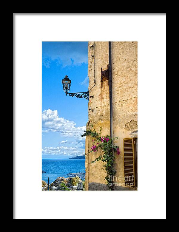 Architecture Framed Print featuring the photograph House with bougainvillea street lamp and distant sea by Silvia Ganora
