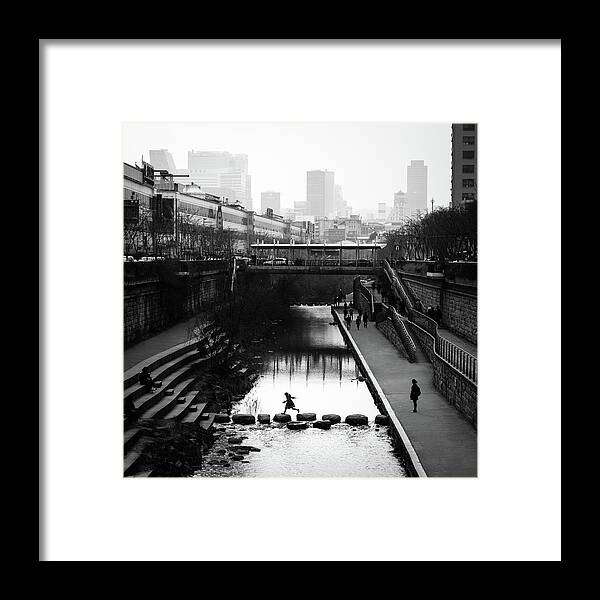 Black Framed Print featuring the photograph Jump - Seoul, South Korea - Black and white street photography by Giuseppe Milo