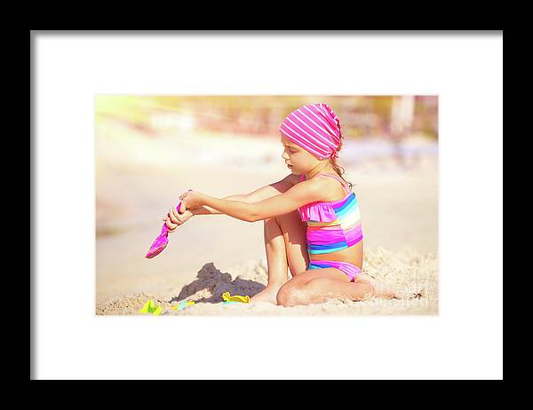 Active Framed Print featuring the photograph Little girl playing on the beach by Anna Om