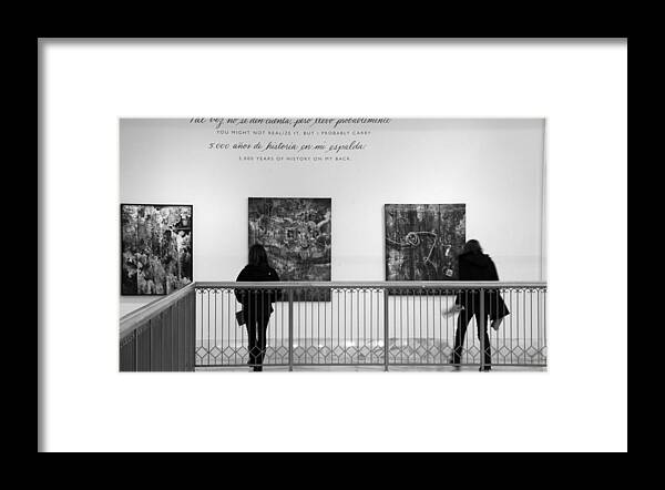 2 Women Wearing Dark Coats Are Observing Art Exhibit Framed Print featuring the photograph Lost in Art by Valerie Collins