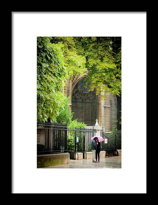 Notre Dame Framed Print featuring the photograph Love in the Rain at Notre Dame by Roberta Kayne