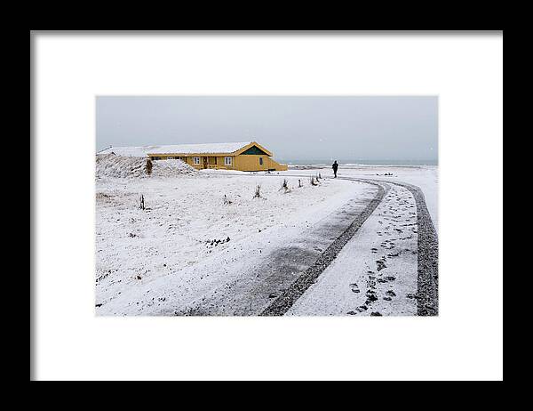 Iceland Framed Print featuring the photograph Man walking in snow Iceland by Michalakis Ppalis