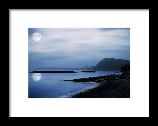 Atmospheric Framed Print featuring the photograph Moonlit beach by Jaroslaw Grudzinski