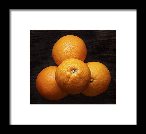 Naval Oranges Framed Print featuring the photograph Naval Oranges on Wood Background by Donald Erickson