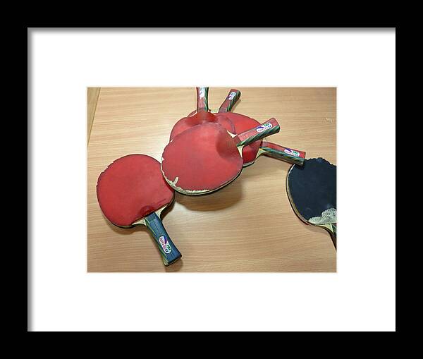 Table Framed Print featuring the photograph Number of ping pong bats piled on a table by Ashish Agarwal