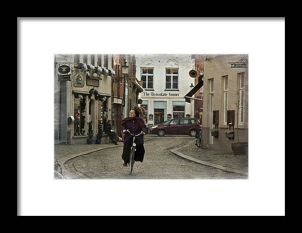 Architecture Framed Print featuring the photograph Nun on a Bicycle in Bruges by Joan Carroll