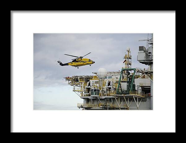 Helicopter Framed Print featuring the photograph Oil worker Helicopter Landing on Rig. by Bradford Martin
