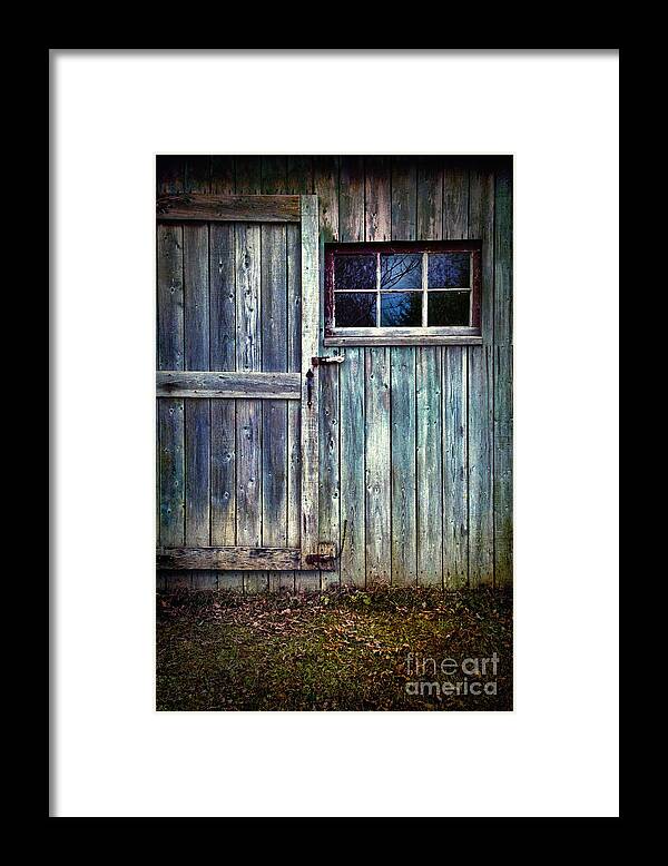 Atmosphere Framed Print featuring the photograph Old shed door with spooky shadow in window by Sandra Cunningham