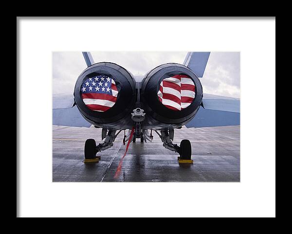 Mcdonnell Douglas F/a-18 Hornet Framed Print featuring the photograph Patriotic American Flag covers on the rear of an American F/A-18 Hornet fighter combat jet aircraft. by Gary Corbett