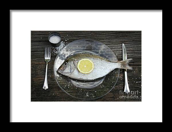 Fish Framed Print featuring the photograph Raw fish on plate with knife and fork by Sandra Cunningham