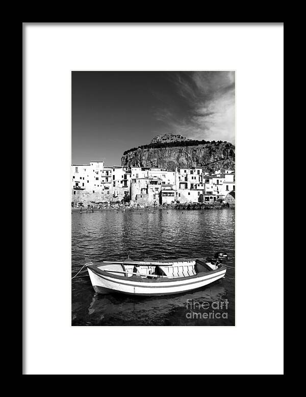 Fishing Boat Framed Print featuring the photograph Rowboat along an idyllic Sicilian village. by Stefano Senise