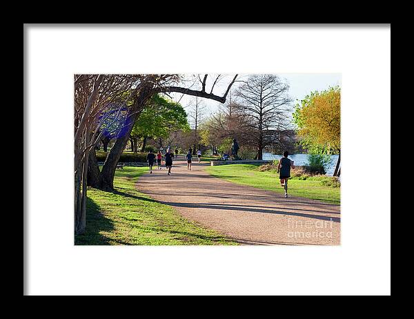 Stevie Ray Vaughan Statue Framed Print featuring the photograph Runners and joggers on the hike and bike trail town lake Austin Texas by Dan Herron