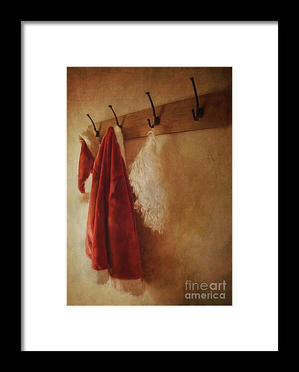Background Framed Print featuring the photograph Santa costume hanging on coat hook/Digital painting by Sandra Cunningham