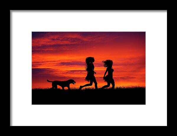Silhouette Framed Print featuring the photograph Silhouette of two girls and dog by Maggie Mccall