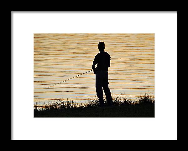 Fisherman Framed Print featuring the photograph Silhouetted Fisherman by Teresa Blanton
