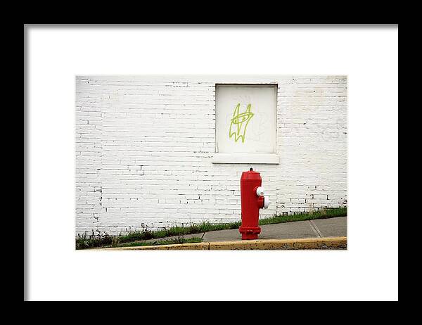 Space Invader Framed Print featuring the photograph Space Invader And The Unsuspecting Hydrant by Kreddible Trout