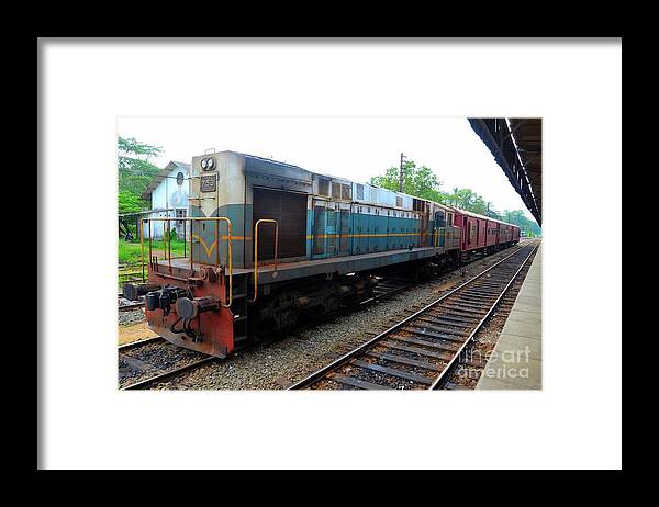 Railways Framed Print featuring the photograph Sri Lankan Railways locomotive train engine with passenger carriages parked at station by Imran Ahmed