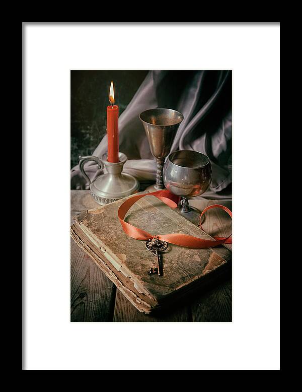 Lit Framed Print featuring the photograph Still life with old book and metal dishes by Jaroslaw Blaminsky