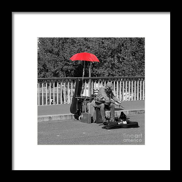 Paris Framed Print featuring the photograph The Busker with the Red Umbrella by Lynn Bolt