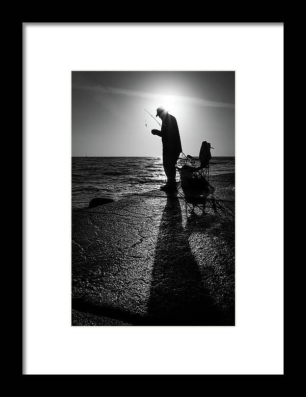 Black Framed Print featuring the photograph The fisherman - Treasure Island, Florida - Black and white street photography by Giuseppe Milo