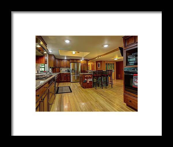 Real Estate Photography Framed Print featuring the photograph This is the kitchen and dining room of the Burns Rd Chalet by Jeff Kurtz