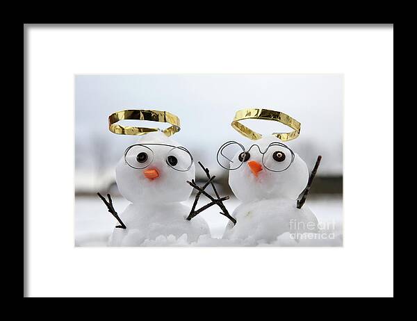 Snowmen Framed Print featuring the photograph Two cute snowman angles with golden halos by Simon Bratt