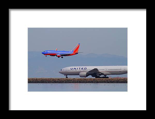 Southwest Framed Print featuring the photograph United Airlines And Southwest Airlines Jet Airplane At San Francisco International Airport SFO.12087 by Wingsdomain Art and Photography