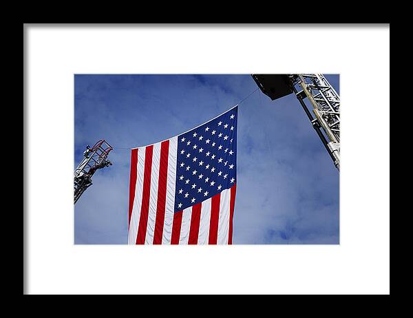  Flag Framed Print featuring the photograph United States Flag Between Fire Ladders by Phil Cardamone