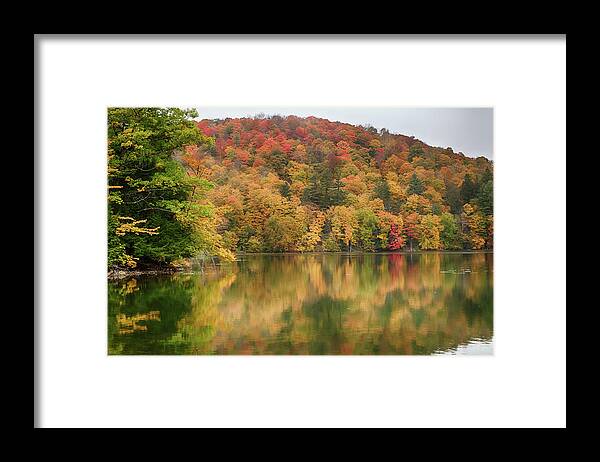 Abenaki Framed Print featuring the photograph Vermont fall foliage reflected on Pogue Pond by Jeff Folger