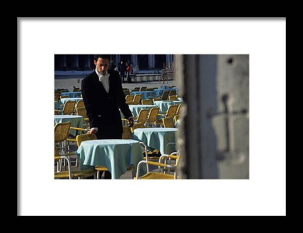 Venice Framed Print featuring the photograph Waiter Preparing for the day in Piazza San Marco in Venice by Michael Henderson