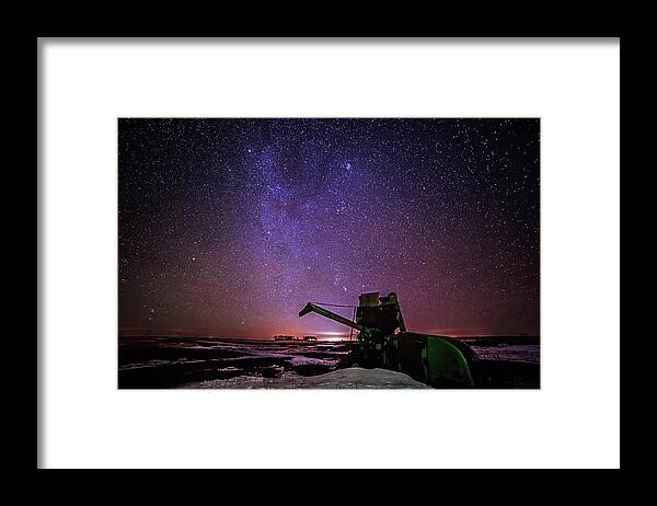 Astroscape Skyscape Night Stars Milky Way Landscape Starscape Combine Harvester Nd Snow Winter Orion North Dakota Cold Purple Green John Deere Framed Print featuring the photograph Waiting for Next Harvest by Peter Herman