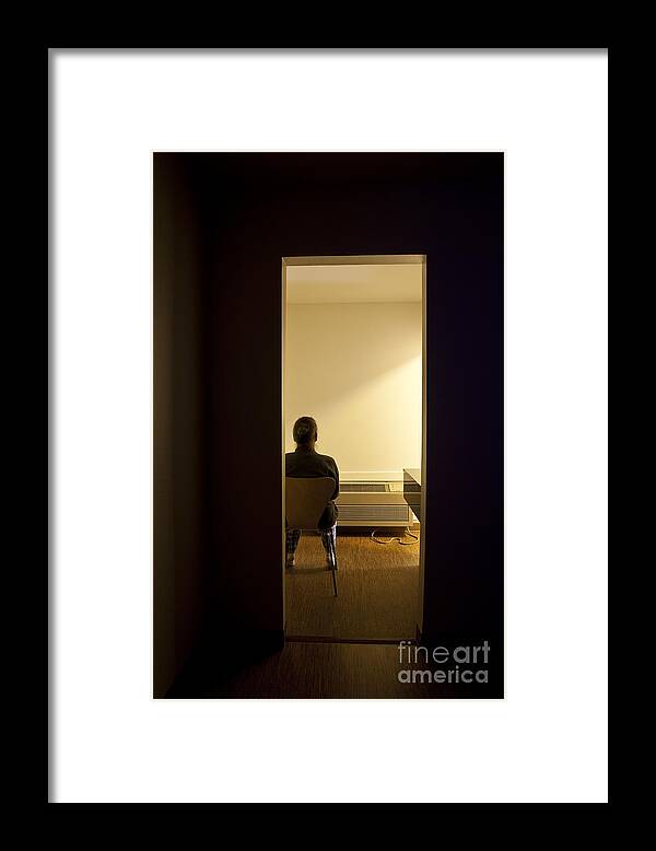 Eccentric Framed Print featuring the photograph Woman in Chair Facing Wall by Jim Corwin