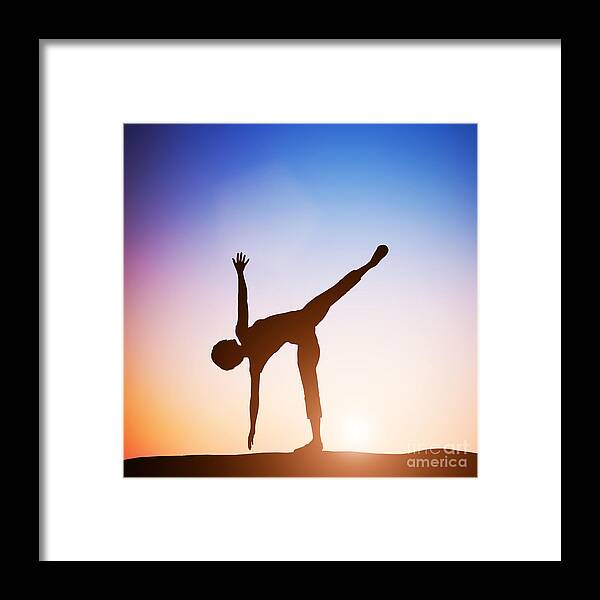 Yoga Framed Print featuring the photograph Woman in half moon yoga pose meditating at sunset by Michal Bednarek