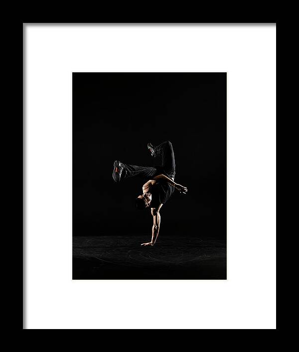 One Man Only Framed Print featuring the photograph Young Male Breakdancer Balancing On One #1 by Thomas Barwick