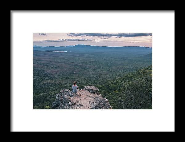 Young Woman Framed Print featuring the photograph Young Woman Sits At The Balconies Admiring The Vast Landscape Of Grampians National Park, Victoria, Australia #1 by Cavan Images