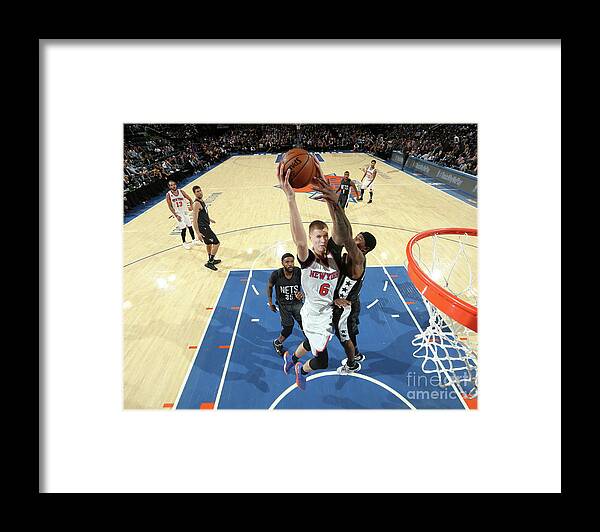 Kristaps Porzingis Framed Print featuring the photograph Brooklyn Nets V New York Knicks by Nathaniel S. Butler