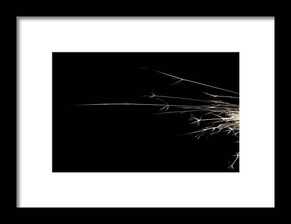 Abstract Framed Print featuring the photograph Abstract light streaks and sparks on black #2 by Karen Foley