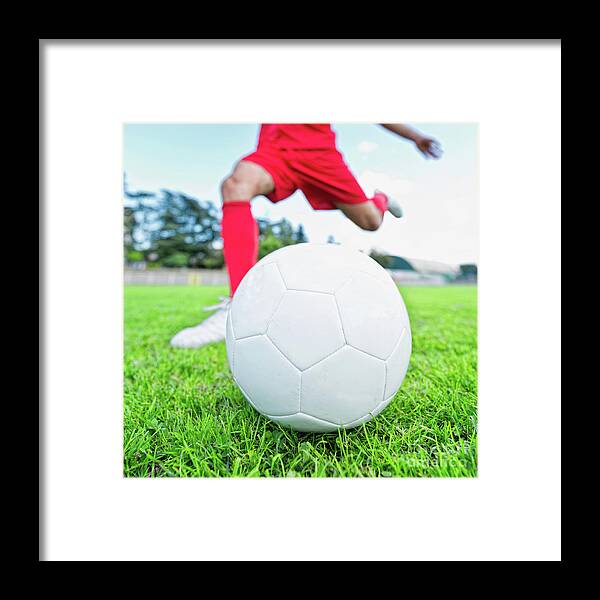Soccer Framed Print featuring the photograph Soccer Player Kicking Ball #3 by Microgen Images/science Photo Library