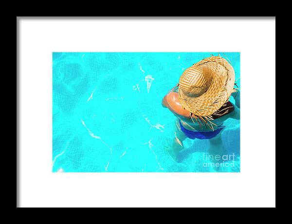 Beautiful Framed Print featuring the photograph Woman in a pool with hat relaxed and rested. #4 by Joaquin Corbalan
