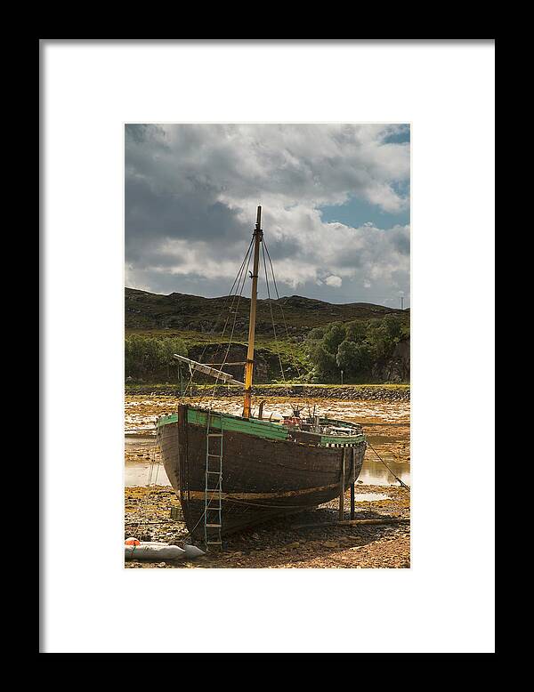 Tide Framed Print featuring the photograph A Boat Sitting On The Shore At Low Tide by John Short / Design Pics