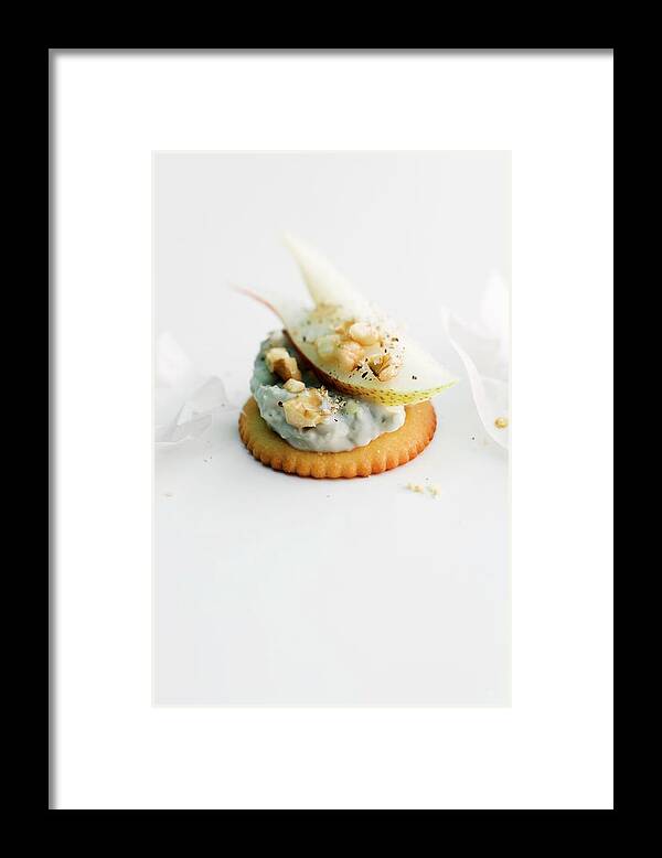 Ip_11237849 Framed Print featuring the photograph A Cracker Topped With Gorgonzola Cream, Pear And Nuts by Michael Wissing