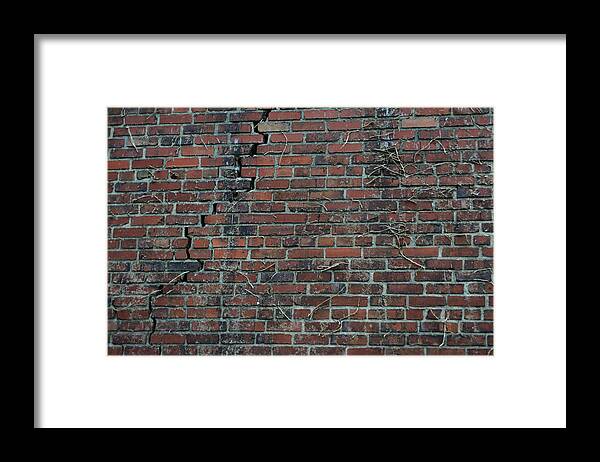 Damaged Framed Print featuring the photograph A Large Crack In Brick Wall by Aaron Mccoy