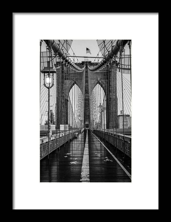 Blackandwhite Framed Print featuring the photograph A Vertical Shot Of The Brooklyn Bridge by WireStock
